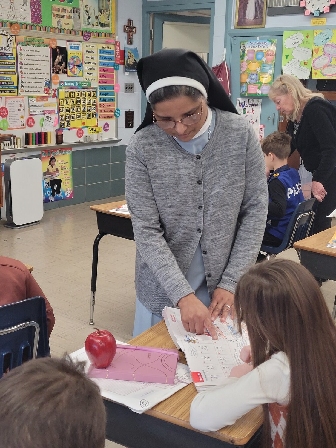 POWER OF PRAYER: St. Rocco’s Sister Daisy Kollamparampil was seriously injured in the Atwood Avenue crosswalk outside the school on Nov. 7, when a driver failed to stop, rear-ending another driver and pushing that vehicle into the crosswalk. Sr. Daisy was struck and sent to the hospital, but she’s convinced the prayers she received from the community helped her recover fast and get back to work teaching second grade.